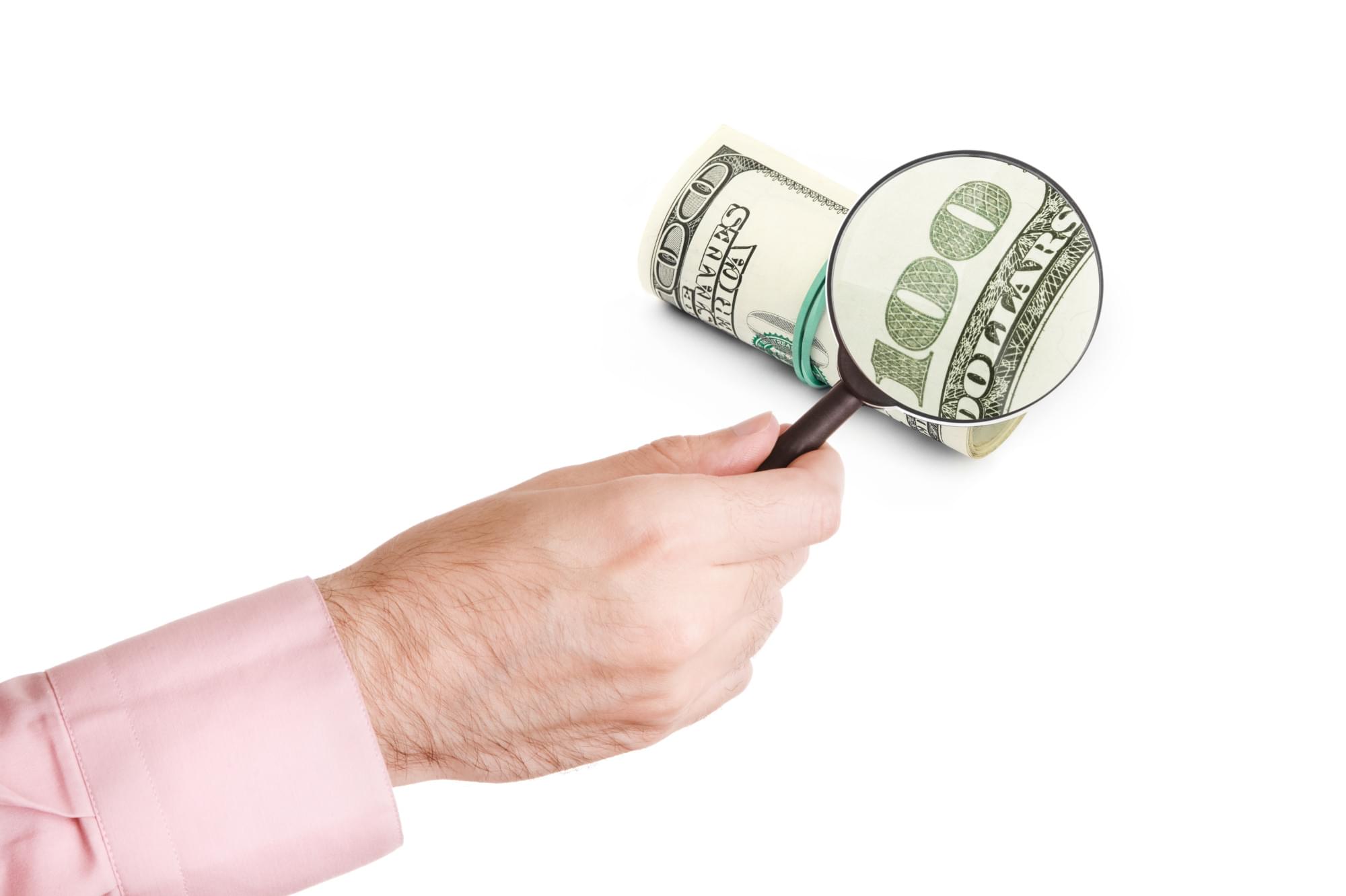 A $100 bill under a magnifying glass